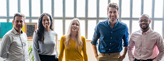 Group of people smiling in the office.